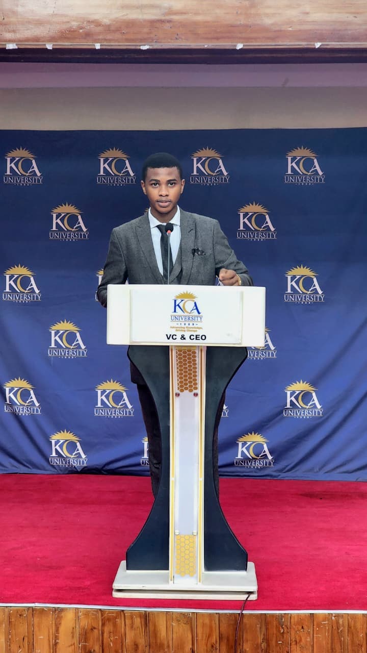 Njaji Samson Sibona speaking on stage.